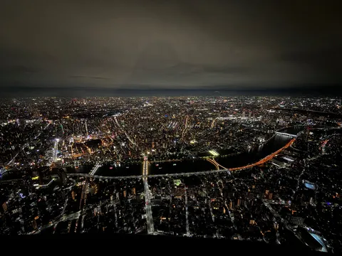 夜景の谷間を走る光の川