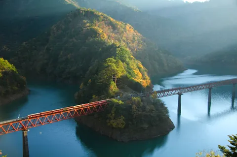 光差す秋の渓谷と鉄橋