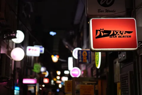 夜の路地に灯る赤看板の魅力