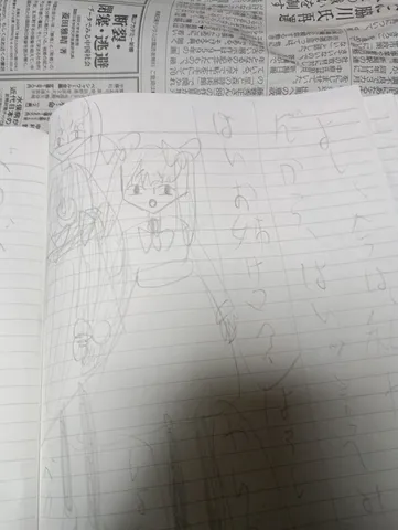 ノートに描いたイラストと新聞