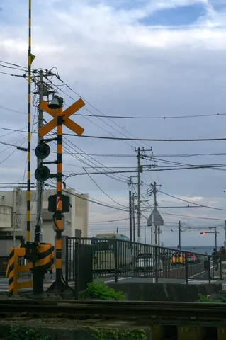 曇り空の踏切、見慣れた日常