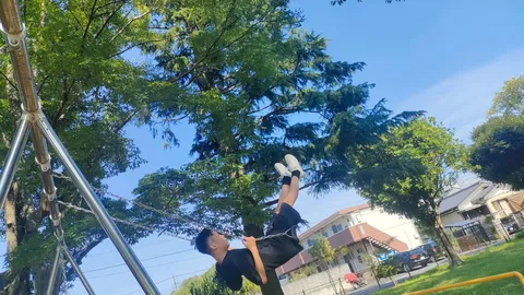ブランコで逆さま、青空と新緑