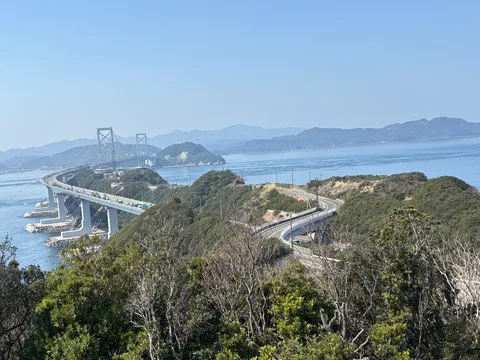 海を渡る巨大な橋と緑の丘