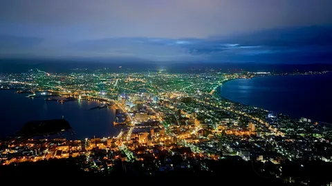 夜景の海辺に光の川