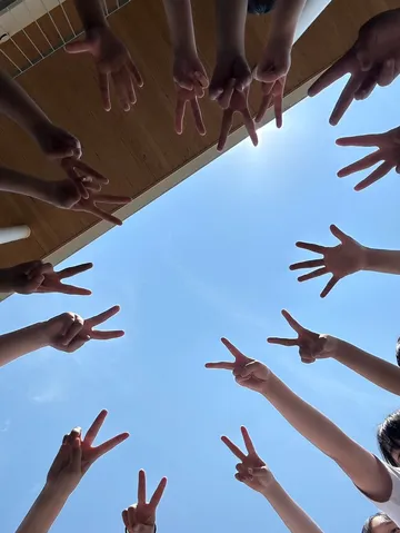 広がる青空と、未来へ向かう手
