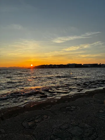 沈む夕陽と穏やかな海辺