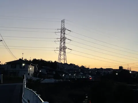 夕景の街と送電塔の余韻