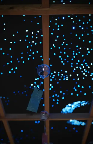 夜空に揺れる風鈴と光の粒
