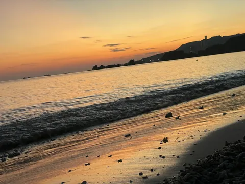 夕暮れの浜辺に揺れる光