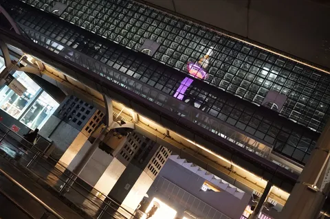 夜のガラス壁に映る紫の塔