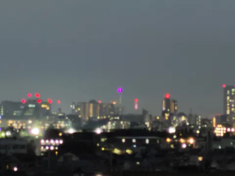 夜景の霧に光る紫の塔