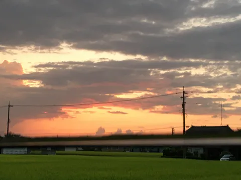 雲間に覗く夕暮れ空と田園