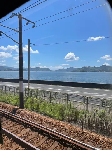 電車の窓から、海と山の風景