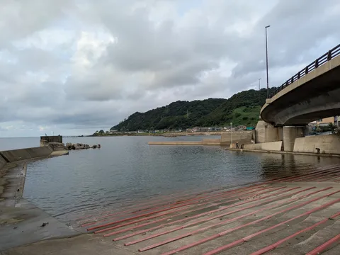 潮風と橋の影が港を横切る