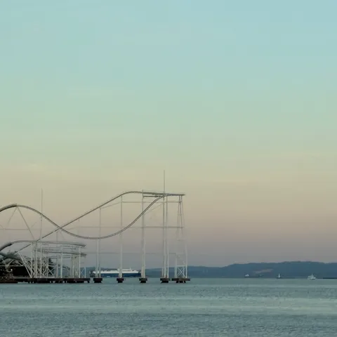 夕暮れに映る、海辺のローラーコースター