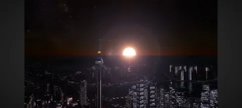 沈む夕日と都会の灯