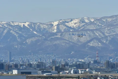 雪化粧の山と街、旅立ちの翼