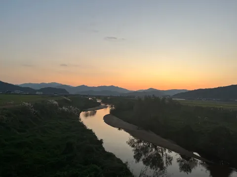 夕暮れの川と山影