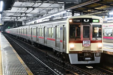 夜の駅、雨に濡れる列車