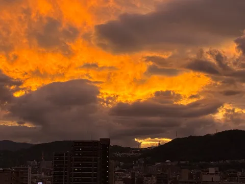 夕焼けの街と山影