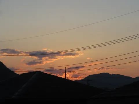 夕暮れの電線と家路