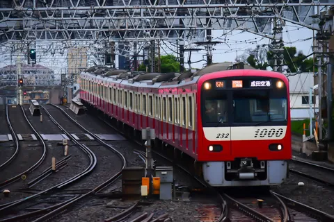 架線を抜ける赤い列車