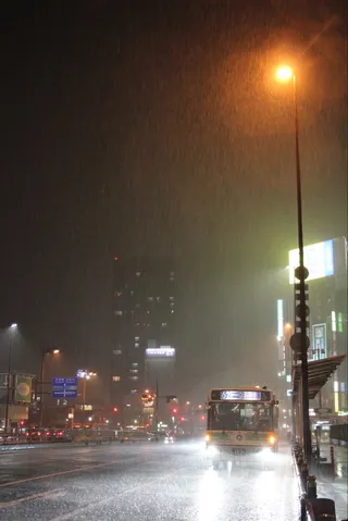 雨夜の街、バスの灯り