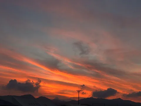 沈む夕陽と長い雲の軌跡