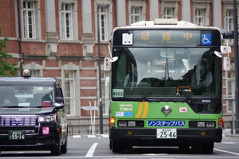 研修中のバスと並走するタクシー