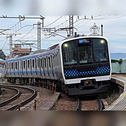 カーブを駆ける青い光の電車