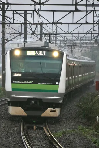 夜の線路を走る緑の列車