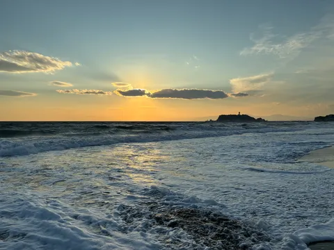 夕暮れの光芒と波の戯れ