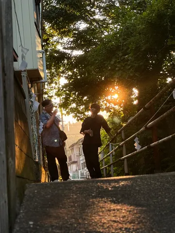 夕暮れの路地で交わる影