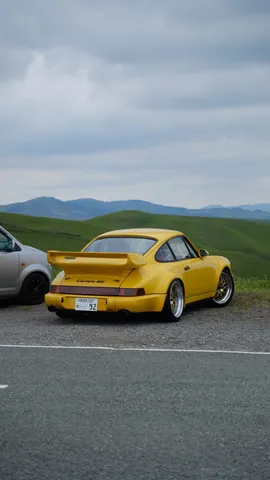 緑の丘と黄色のポルシェ