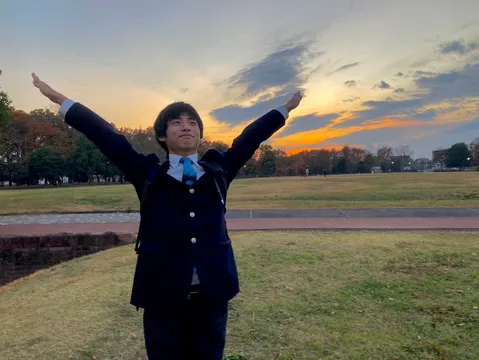 夕陽を背に大きく広がる腕