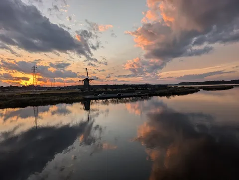 夕暮れのオランダ風車と水面