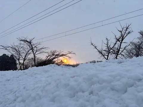 吹雪の向こうの夕日