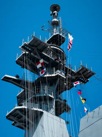 大空に揺れる旗と船の威容