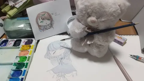 水彩色鉛筆とクマのぬいぐるみ