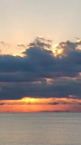 雲間から光が降り注ぐ海