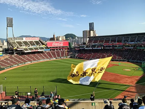 夕暮れのグラウンドに舞う大旗